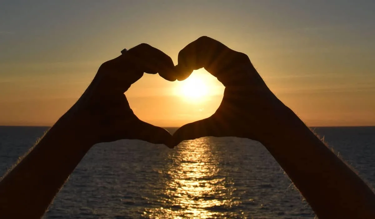Making a heart with my hands at sunset