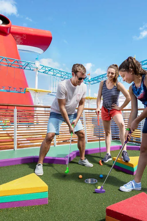 Cruise passengers playing mini golf