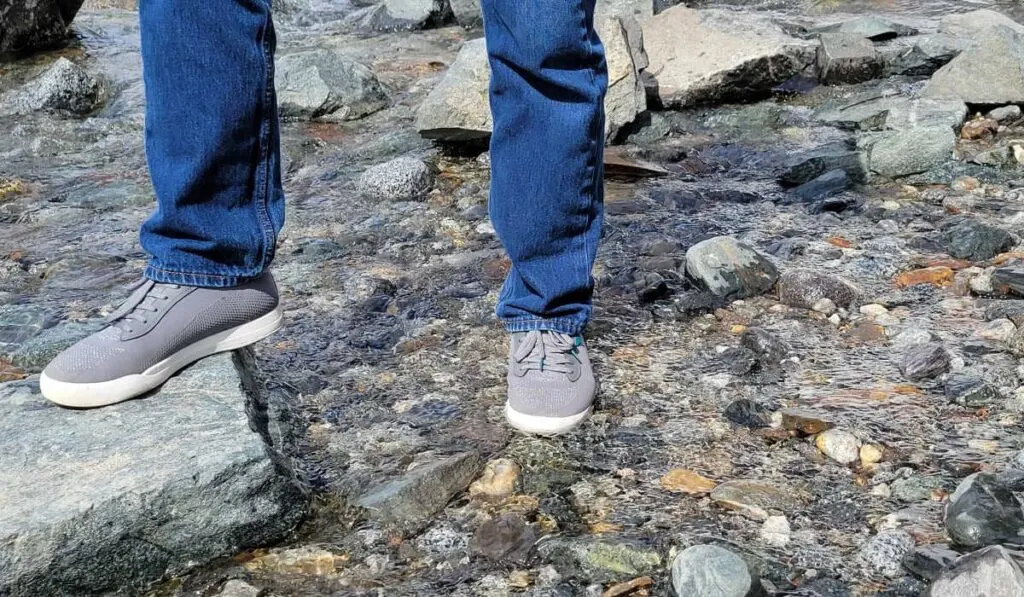 My husband wearing his Vessi Weekenders waterproof shoes in a river