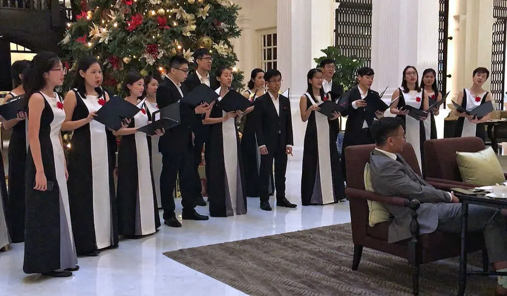 Coral singers serenading guests at Christmas