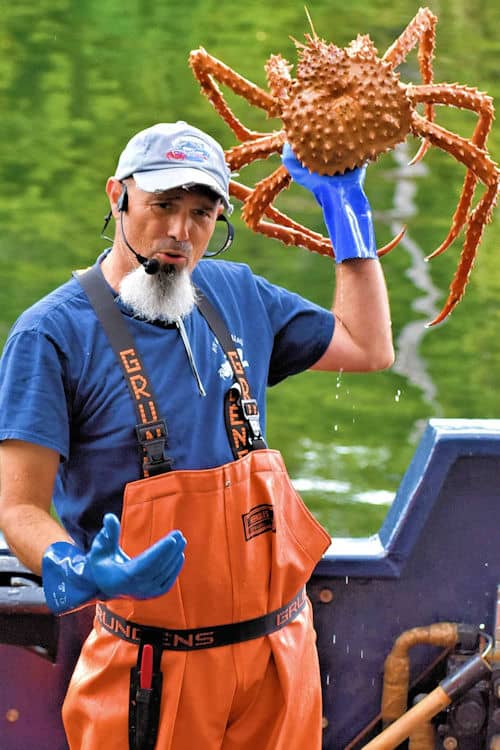 A crew member holds up a 6-year-old Alaskan king crab