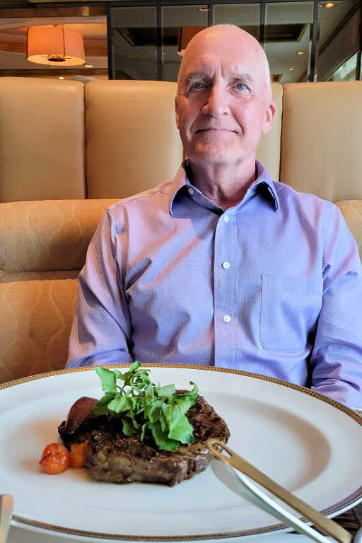 Brian with his 12 oz. ribeye steak from Cunard's specialty restaurant