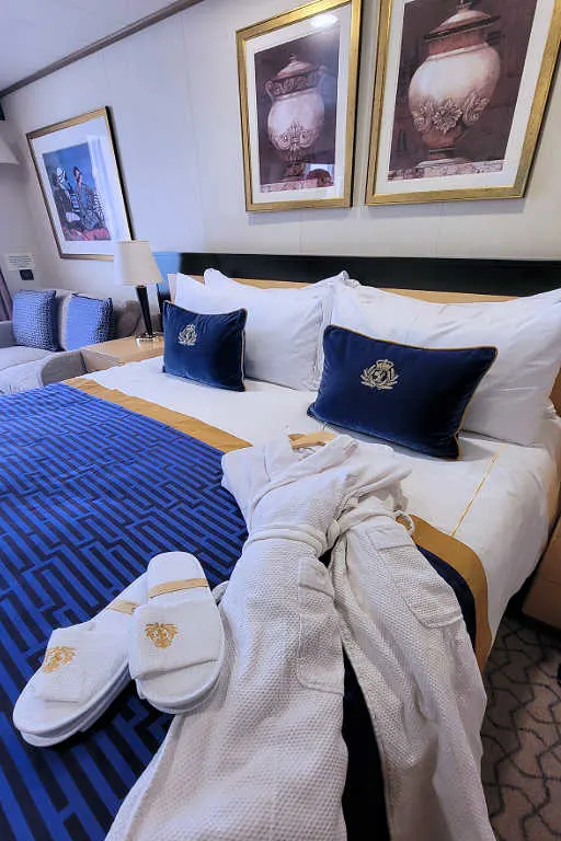 Cunard stateroom, with embroidered cushions, cozy robes, and slippers