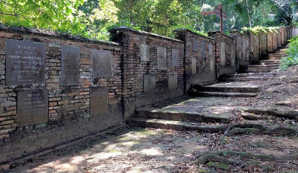 Old cemetery wall with inlaid tombstones, at Fort Canning in Singapore