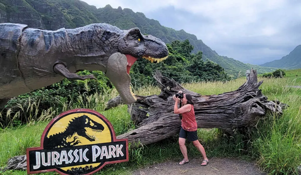 Karen trying to capture the perfect picture of a dinosaur at Jurassic Park