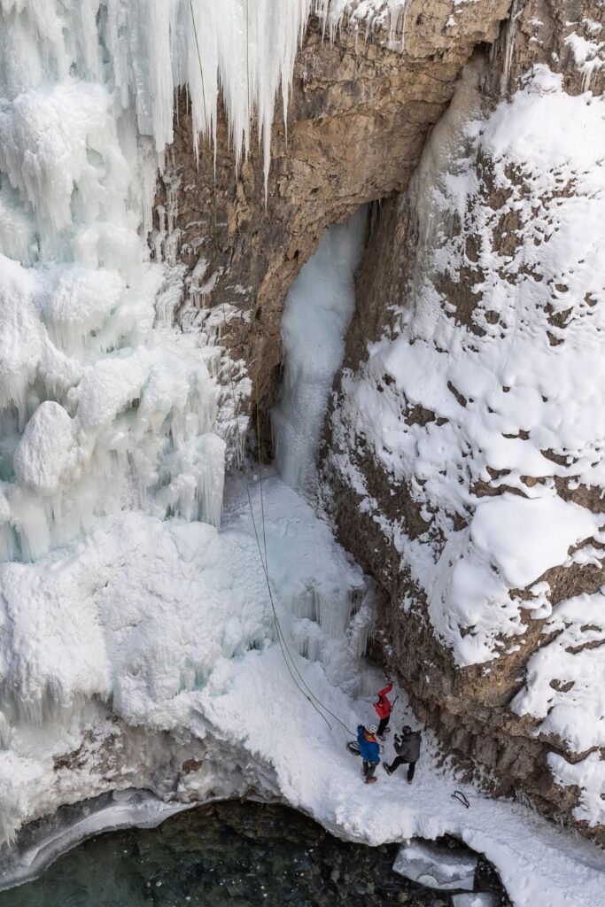 Three people ready to ice climb in Johnston Canyon