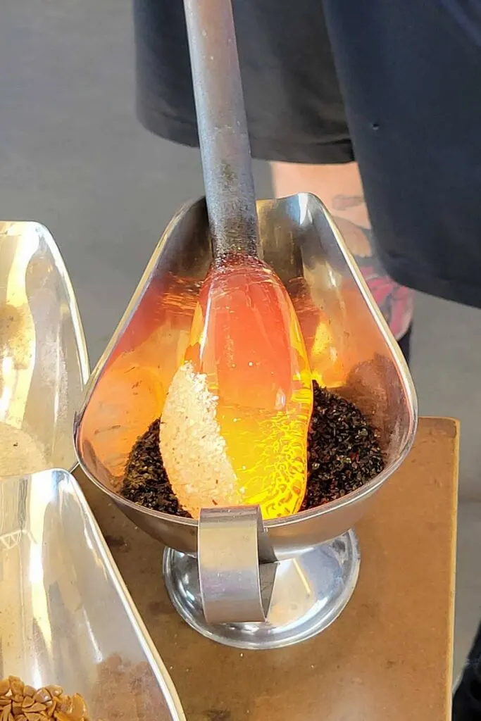 Adding colored oxide to the hot glass