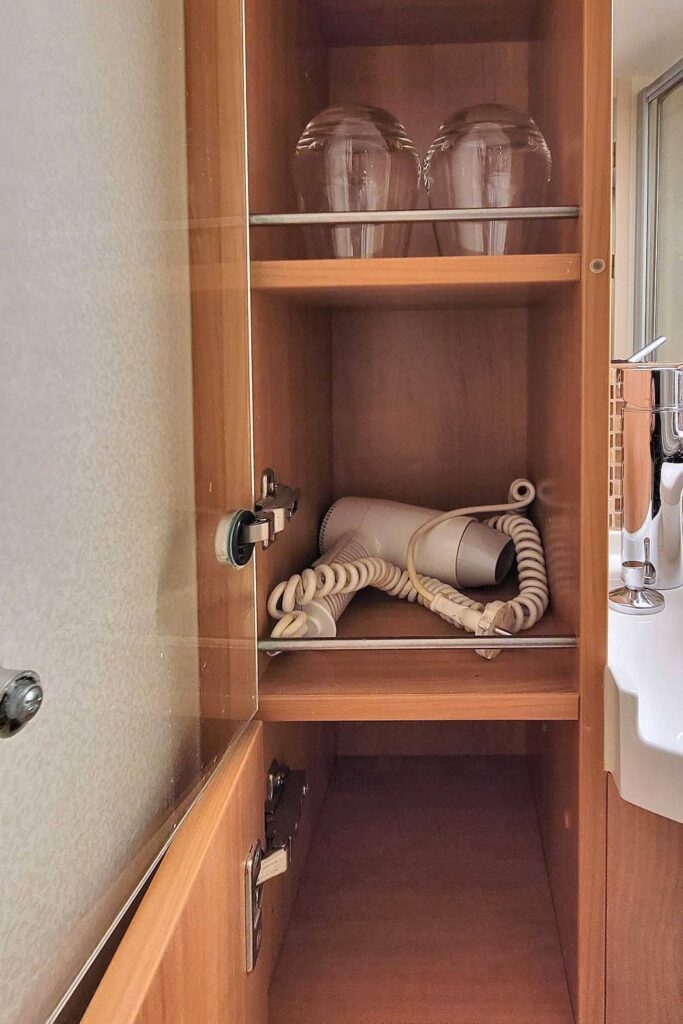 Celebrity Solstice bathroom storage with hair dryer
