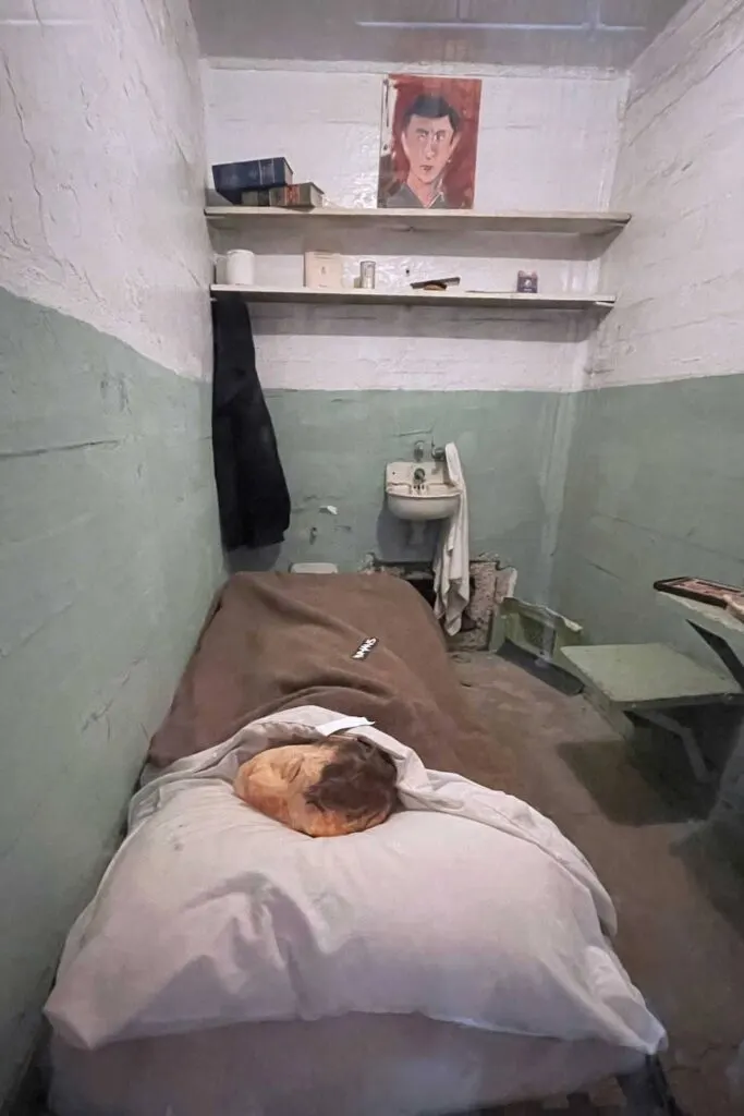 Paper mâché head on the cot in a prison cell