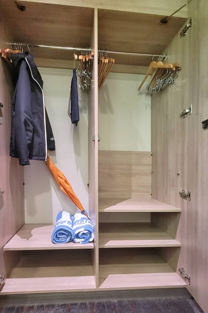 Large closet with towels and an umbrella